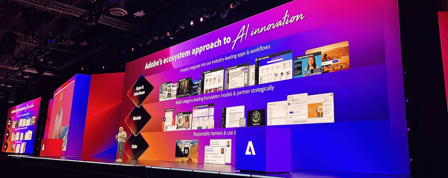 Presenter Discussing Adobe's Ai Innovation Strategy at Adobe Summit on a Large a Vibrant Display Showcasing Apps, Models, and Data Integration.