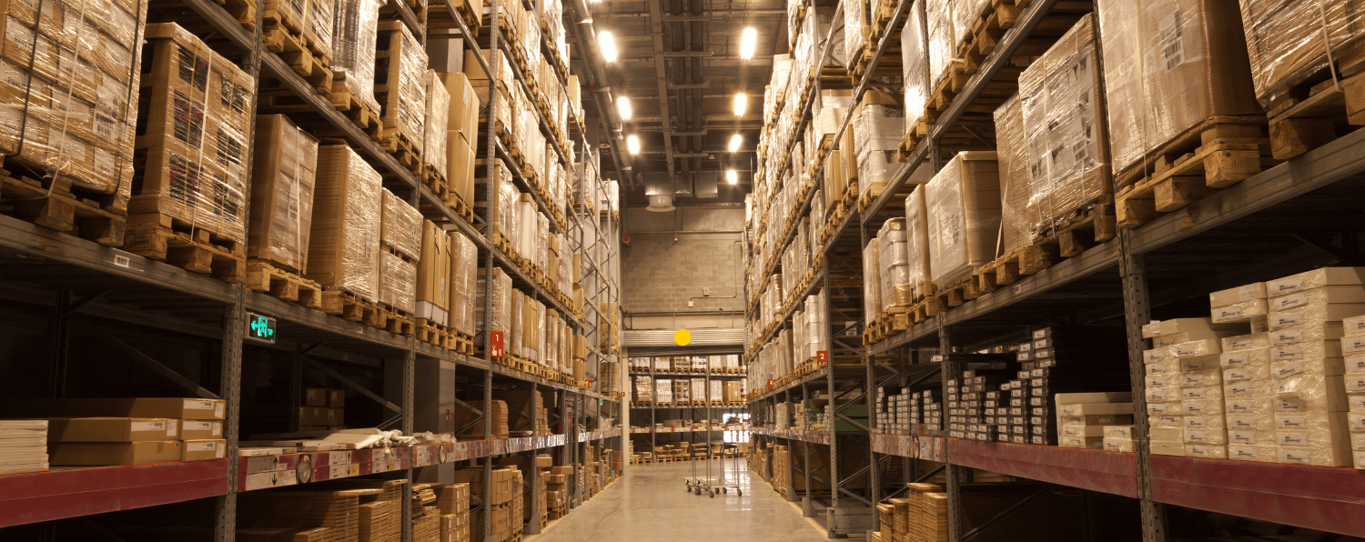 Large Warehouse Interior with Stacked Shelves of Boxed Inventory, Illustrating B2b Distribution Logistics